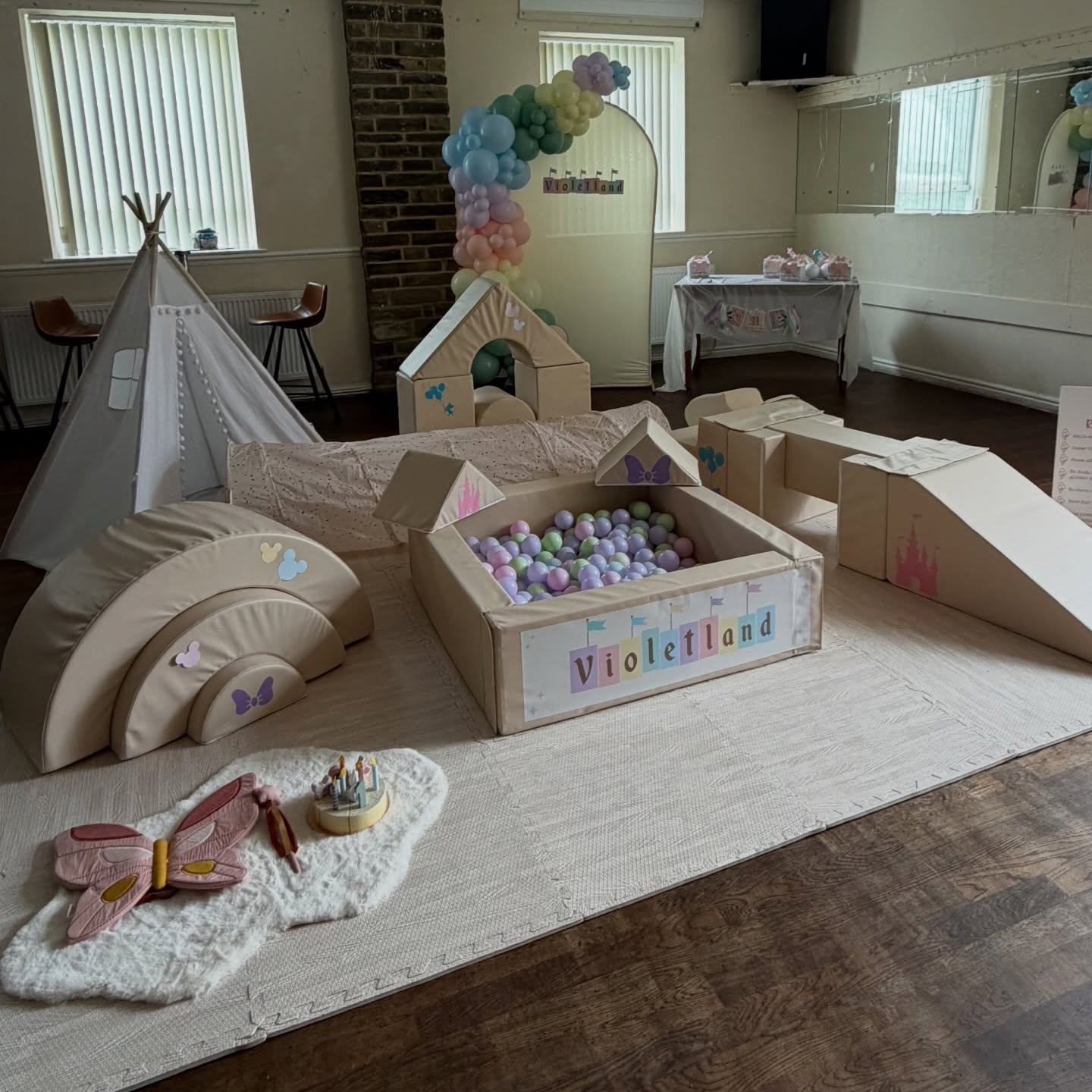 Violetland themed pastel soft play with ball pit, teepee and balloon arch